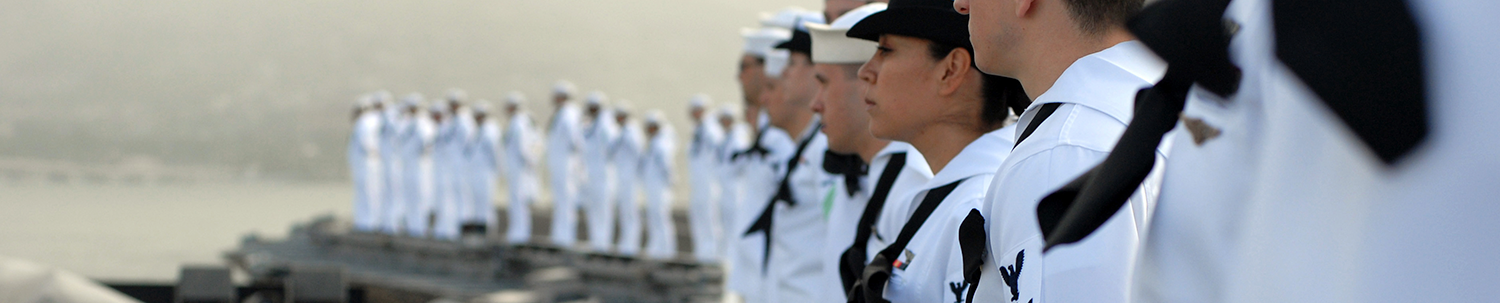 U.S. Navy Service Members standing on battle carrier